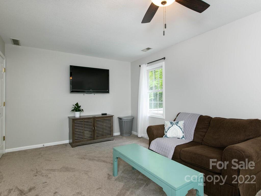 15 Devonshire Drive Candler, NC 28715 - Photo 28 of 43 a living room with furniture and a flat screen tv