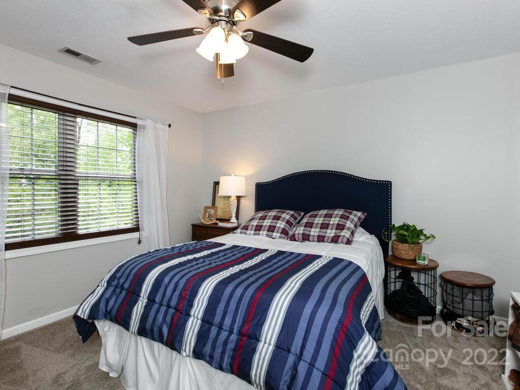 15 Devonshire Drive Candler, NC 28715 - Photo 29 of 43 a bedroom with a bed and a chandelier