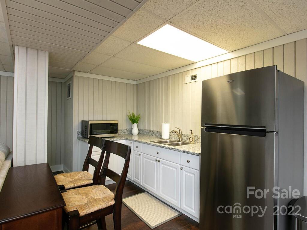 15 Devonshire Drive Candler, NC 28715 - Photo 34 of 43 a kitchen with a refrigerator a table and chairs