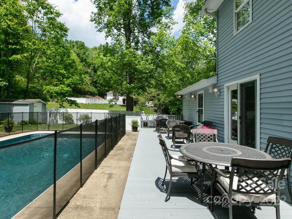 15 Devonshire Drive Candler, NC 28715 - Photo 37 of 43 a roof deck with table and chairs and potted plants with wooden floor and fence