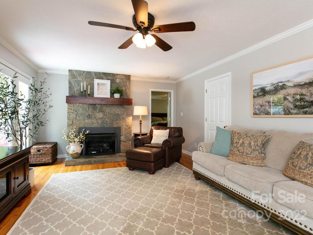 15 Devonshire Drive Candler, NC 28715 - Photo 7 of 43 a living room with furniture a flat screen tv and a fireplace