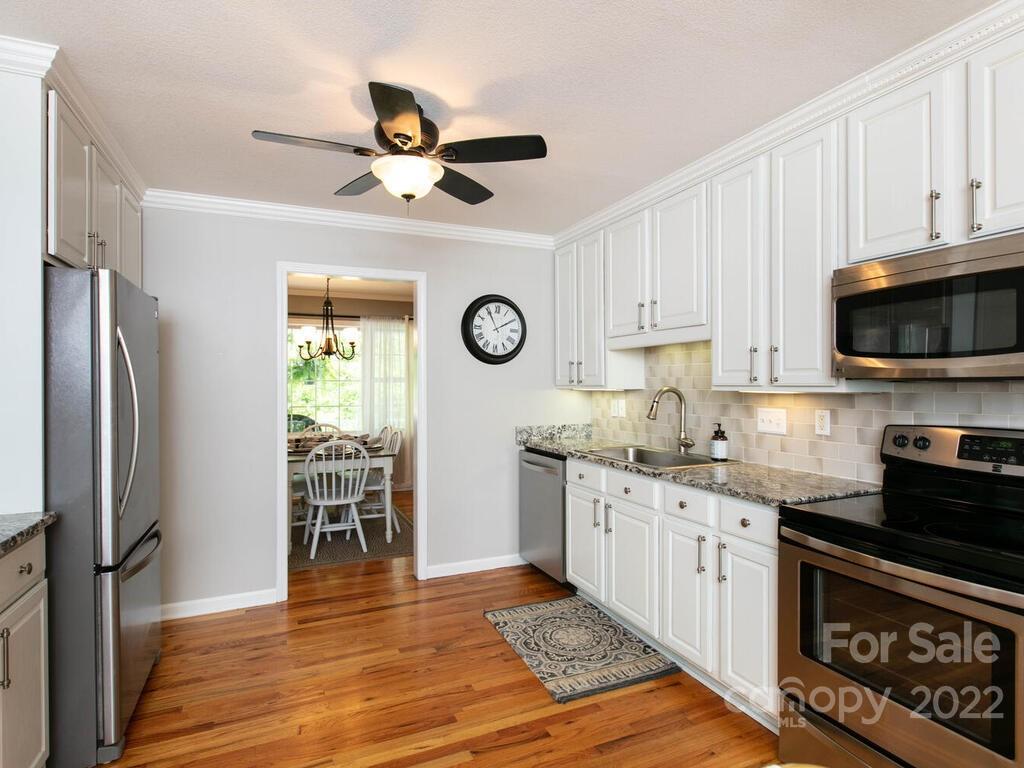 15 Devonshire Drive Candler, NC 28715 - Photo 10 of 43 a kitchen with stainless steel appliances granite countertop a refrigerator a stove and a sink