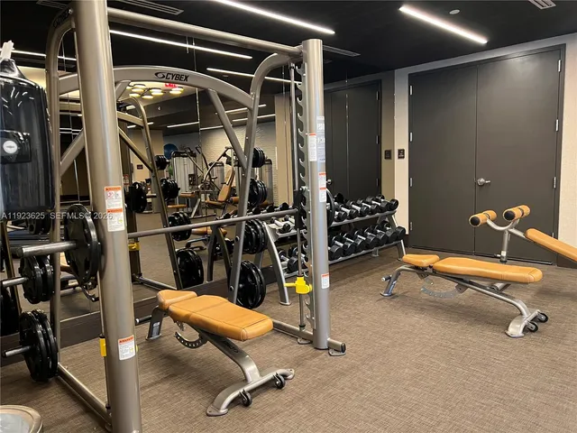 a room with gym equipment and a large window