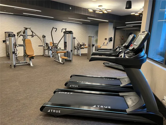 a view of building with yard and large windows