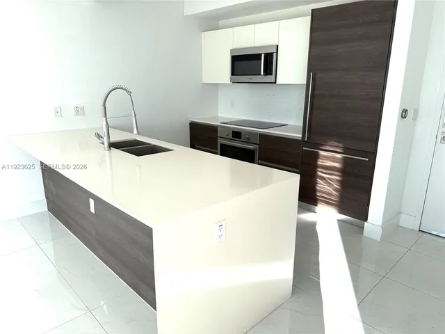 a kitchen with a sink and a microwave
