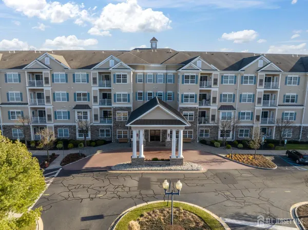 a front view of a residential apartment building with a yard