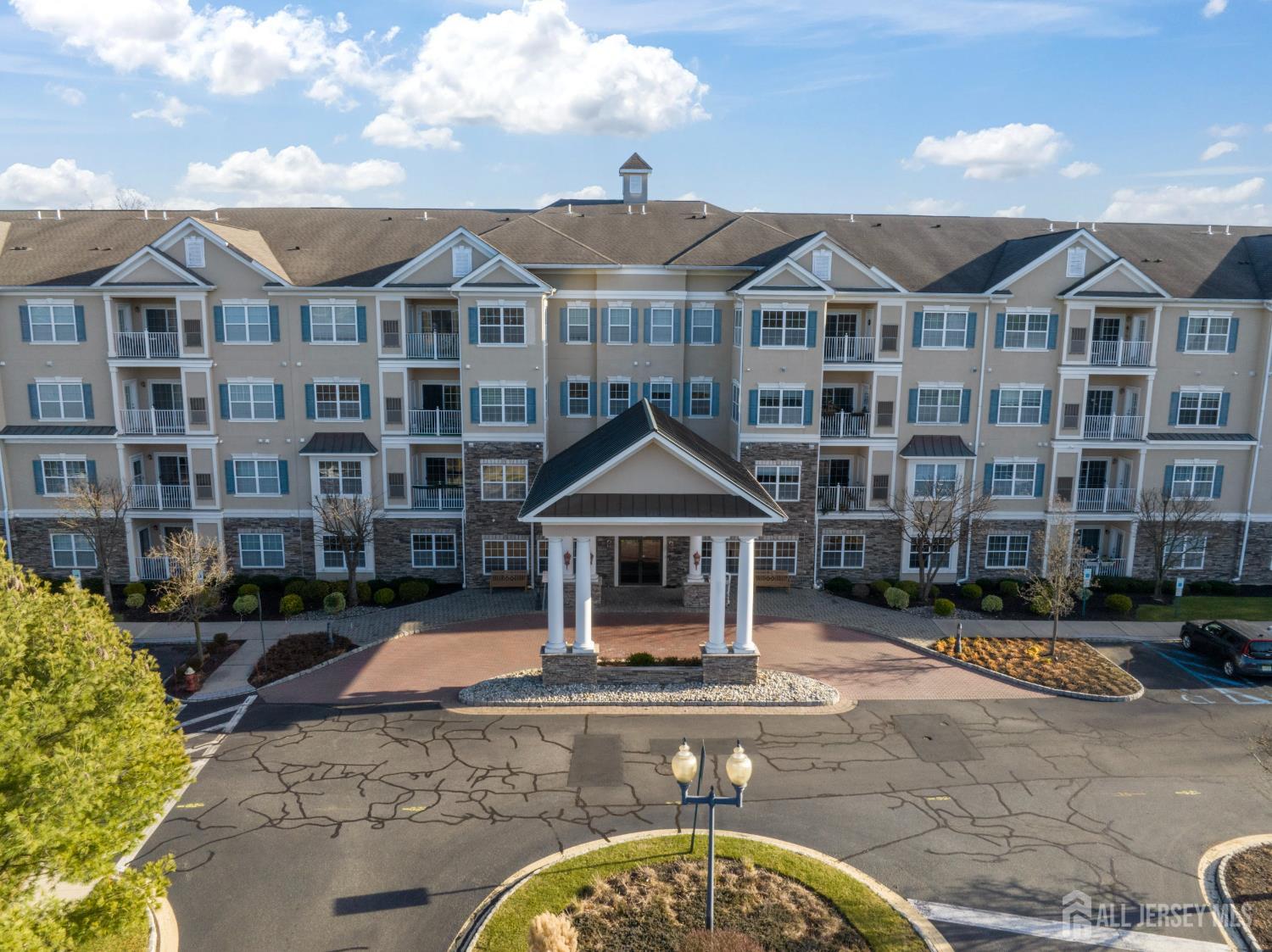 a front view of a residential apartment building with a yard