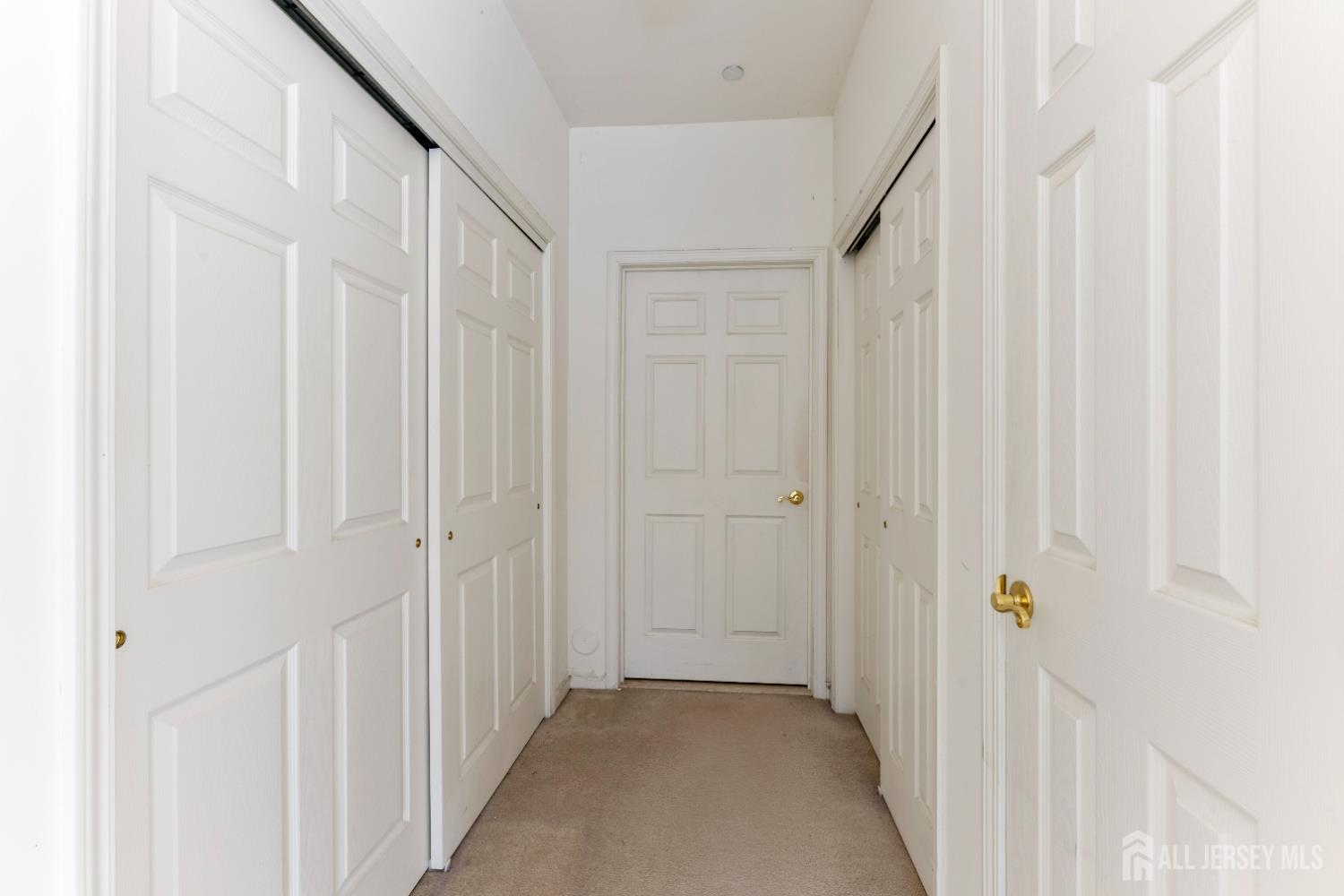 540 Cranbury Road, Unit 104 East Brunswick, NJ 08816 - Photo 16 of 43 a view of a hallway with white doors