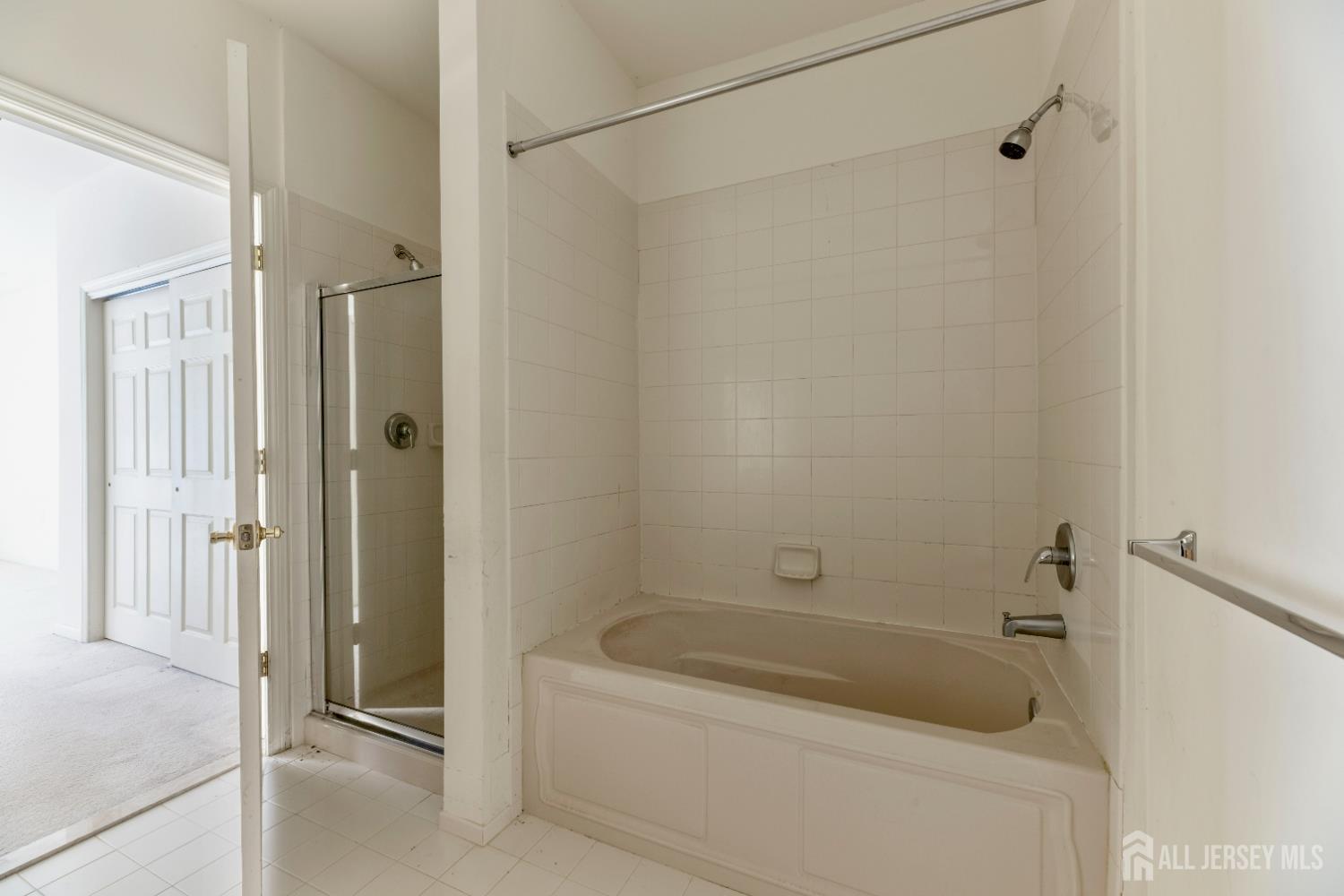 540 Cranbury Road, Unit 104 East Brunswick, NJ 08816 - Photo 18 of 43 a bathroom with a tub a sink and a shower