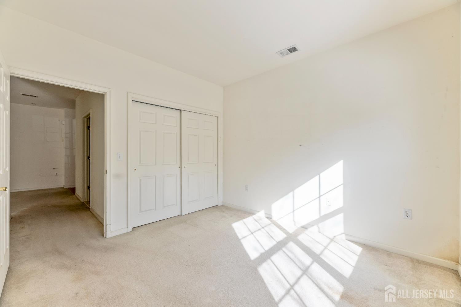 540 Cranbury Road, Unit 104 East Brunswick, NJ 08816 - Photo 20 of 43 a view of an empty room and window