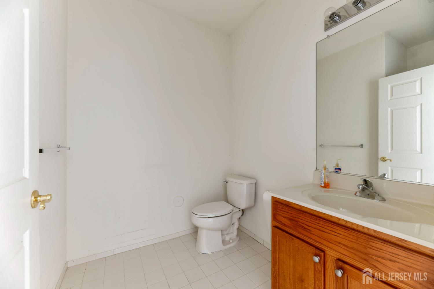 540 Cranbury Road, Unit 104 East Brunswick, NJ 08816 - Photo 21 of 43 a bathroom with a sink a toilet and a mirror