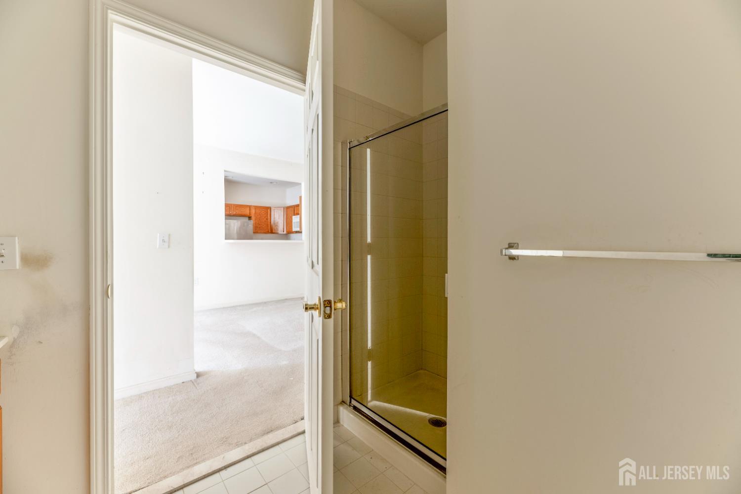 540 Cranbury Road, Unit 104 East Brunswick, NJ 08816 - Photo 22 of 43 a bathroom with a glass shower door