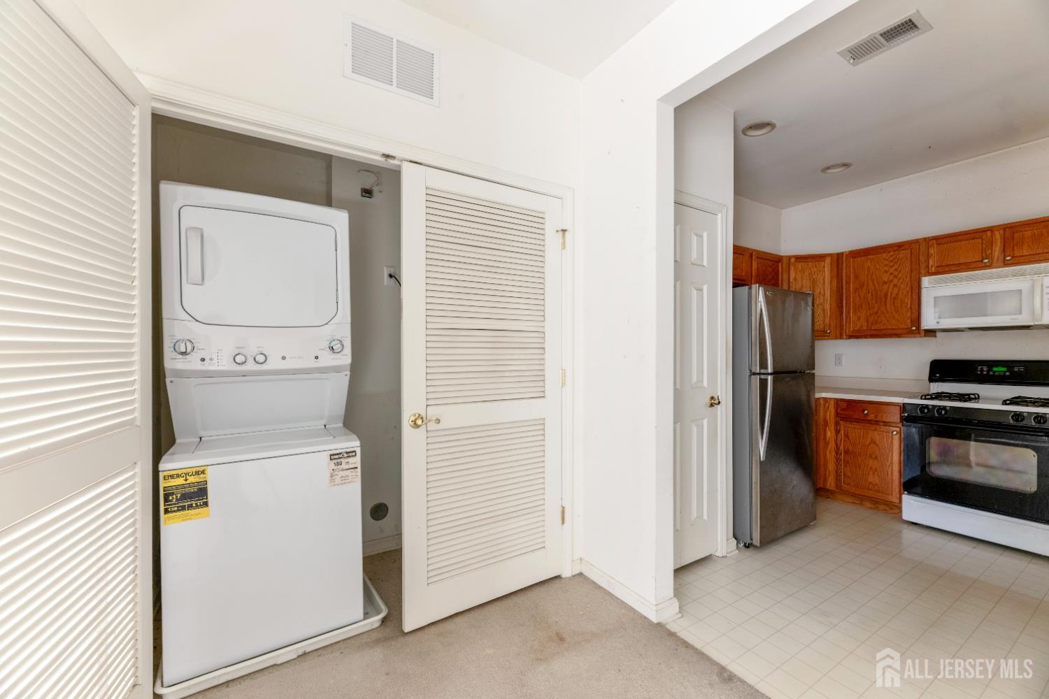 540 Cranbury Road, Unit 104 East Brunswick, NJ 08816 - Photo 23 of 43 a view of a kitchen with a refrigerator a stove top oven and a refrigerator