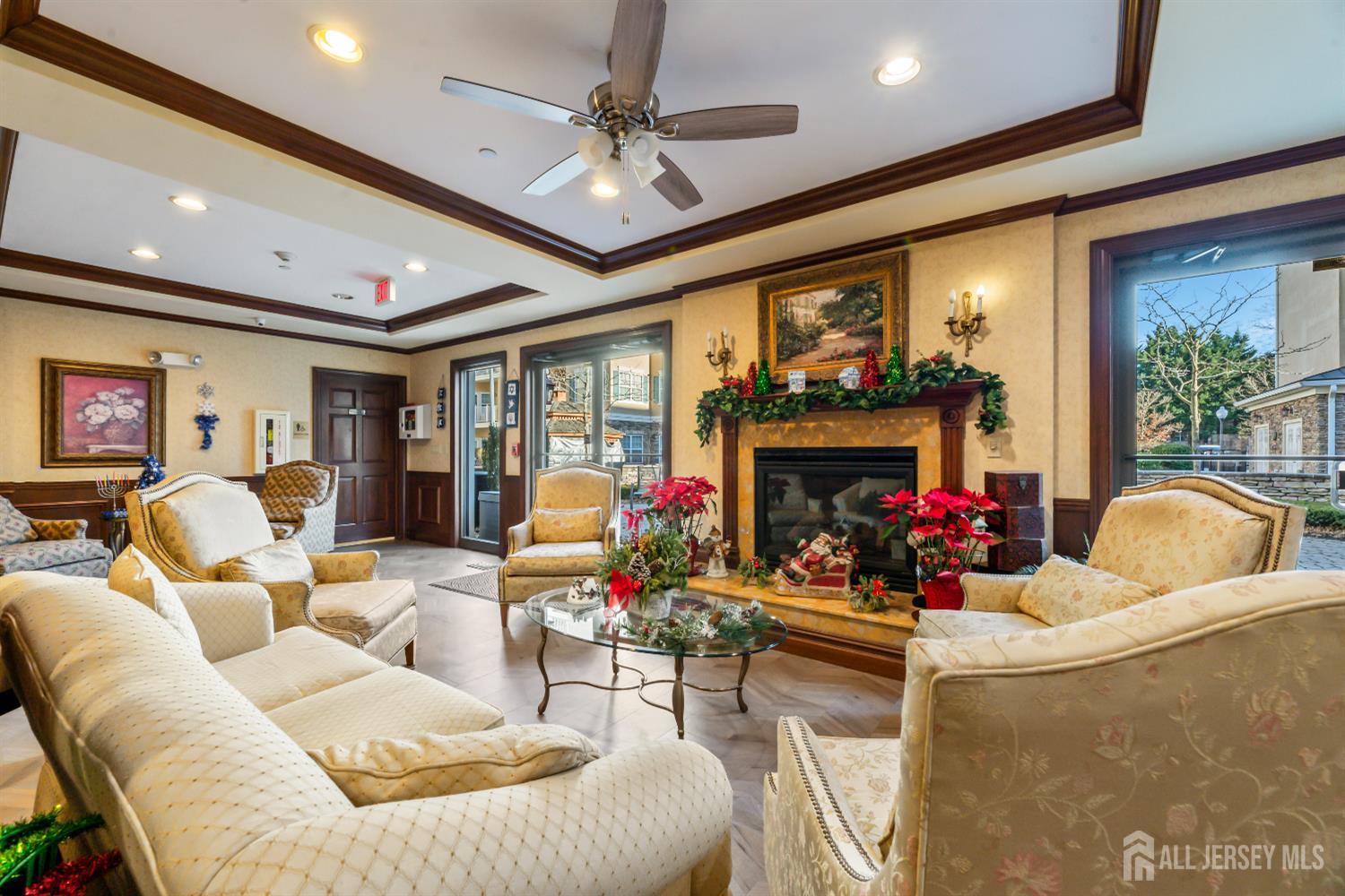540 Cranbury Road, Unit 104 East Brunswick, NJ 08816 - Photo 29 of 43 a living room with furniture a fireplace and a flat screen tv