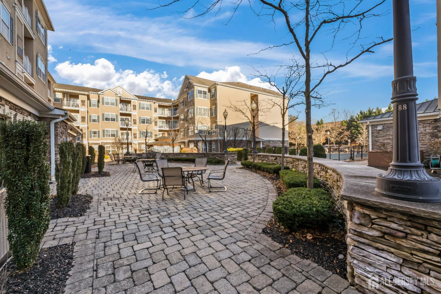 540 Cranbury Road, Unit 104 East Brunswick, NJ 08816 - Photo 38 of 43 a view of a patio with dining table and chairs