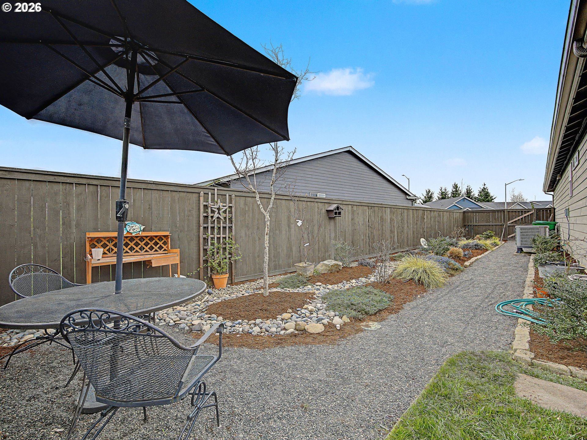 245 Northeast Hill Way Estacada, OR 97023 - Photo 39 of 45 a view of a backyard with table and chairs under an umbrella