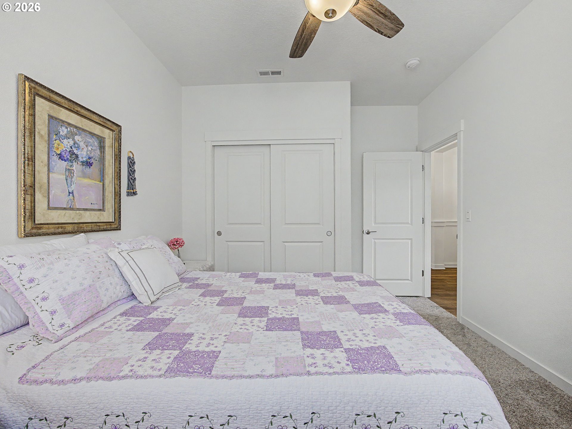 245 Northeast Hill Way Estacada, OR 97023 - Photo 8 of 45 a bedroom with a large bed and a chandelier