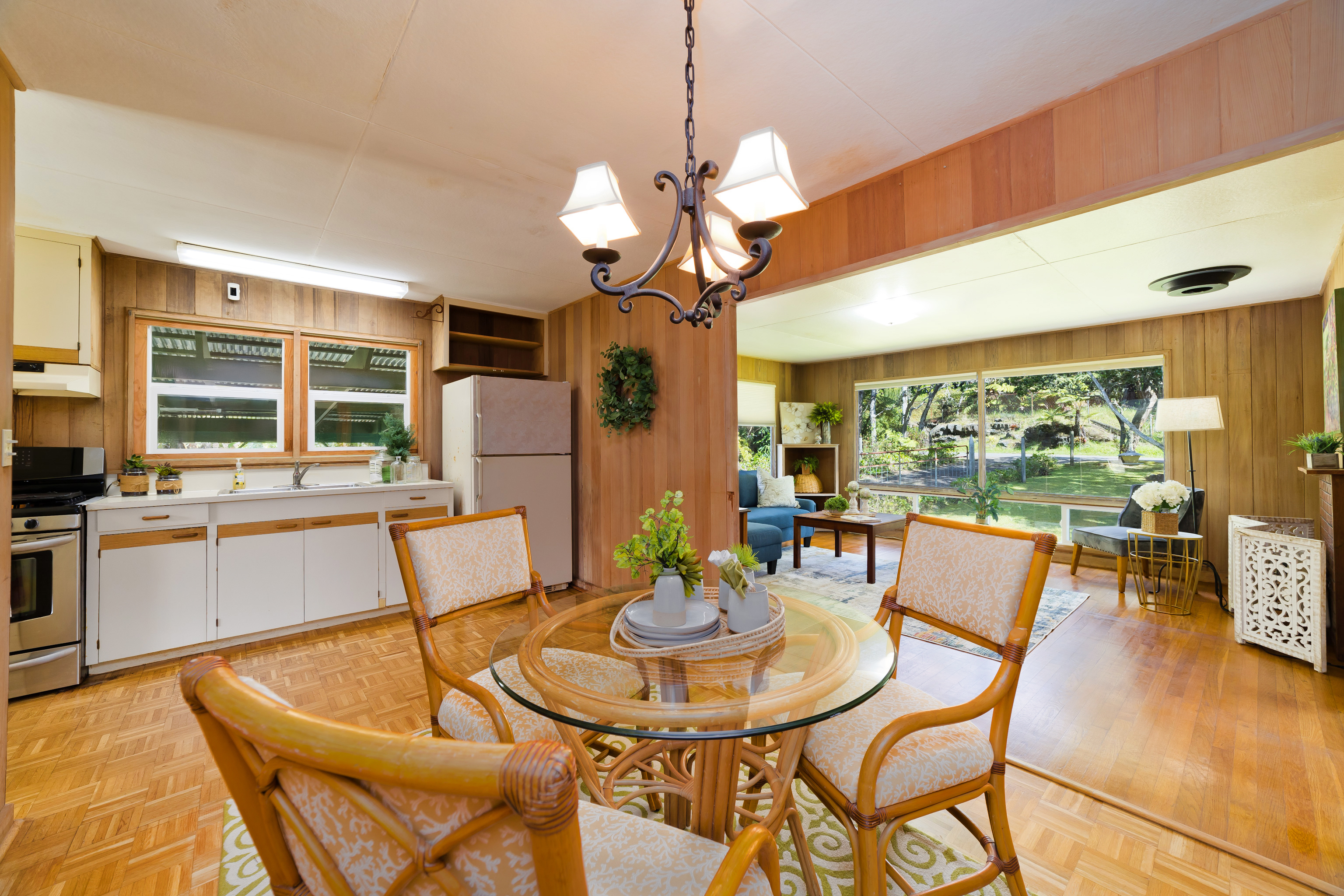 19-4113 Haunani Road Volcano, HI 96785 - Photo 13 of 30 a dining room with wooden floor a chandelier a glass table and chairs