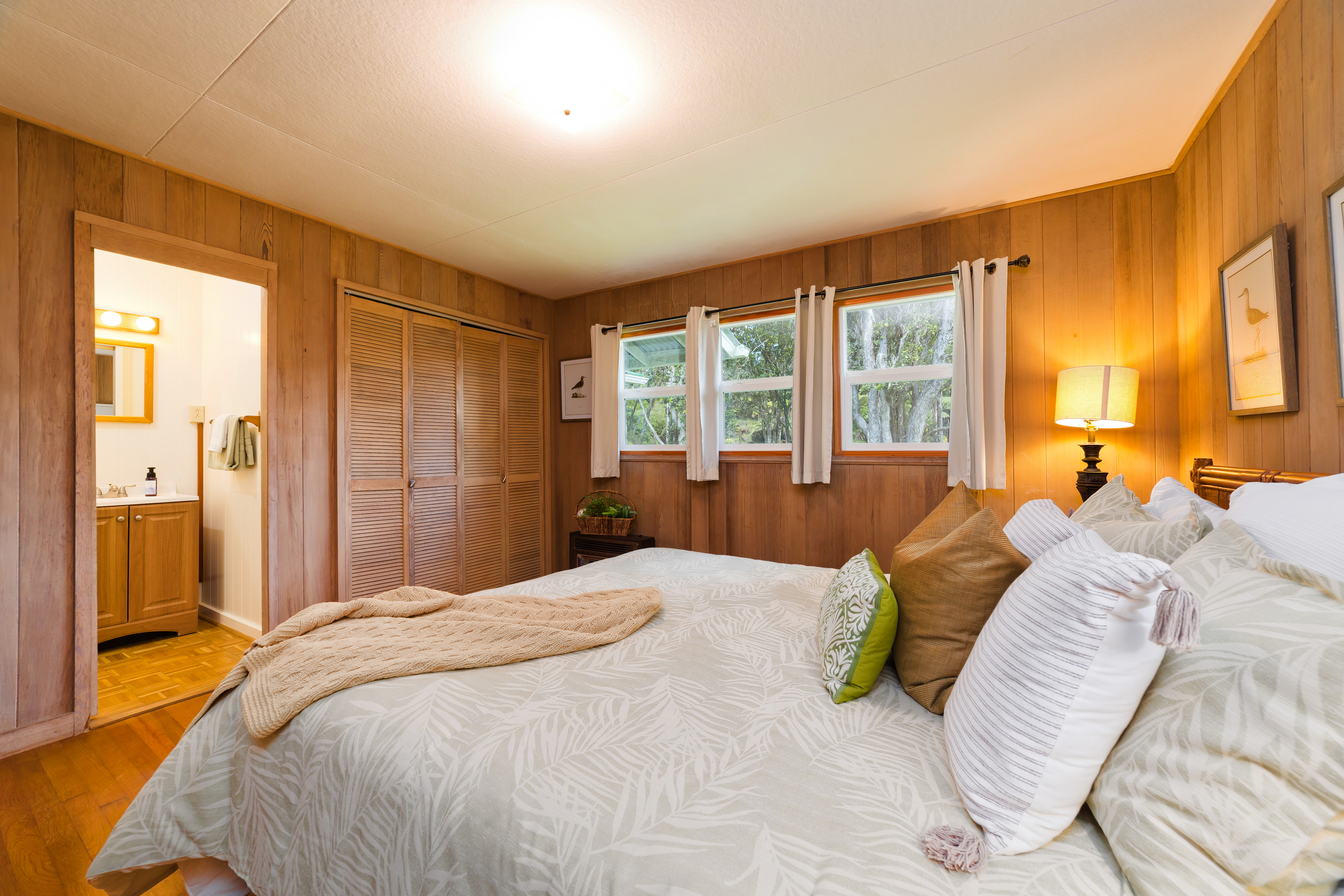 19-4113 Haunani Road Volcano, HI 96785 - Photo 19 of 30 a bedroom with a bed and large windows
