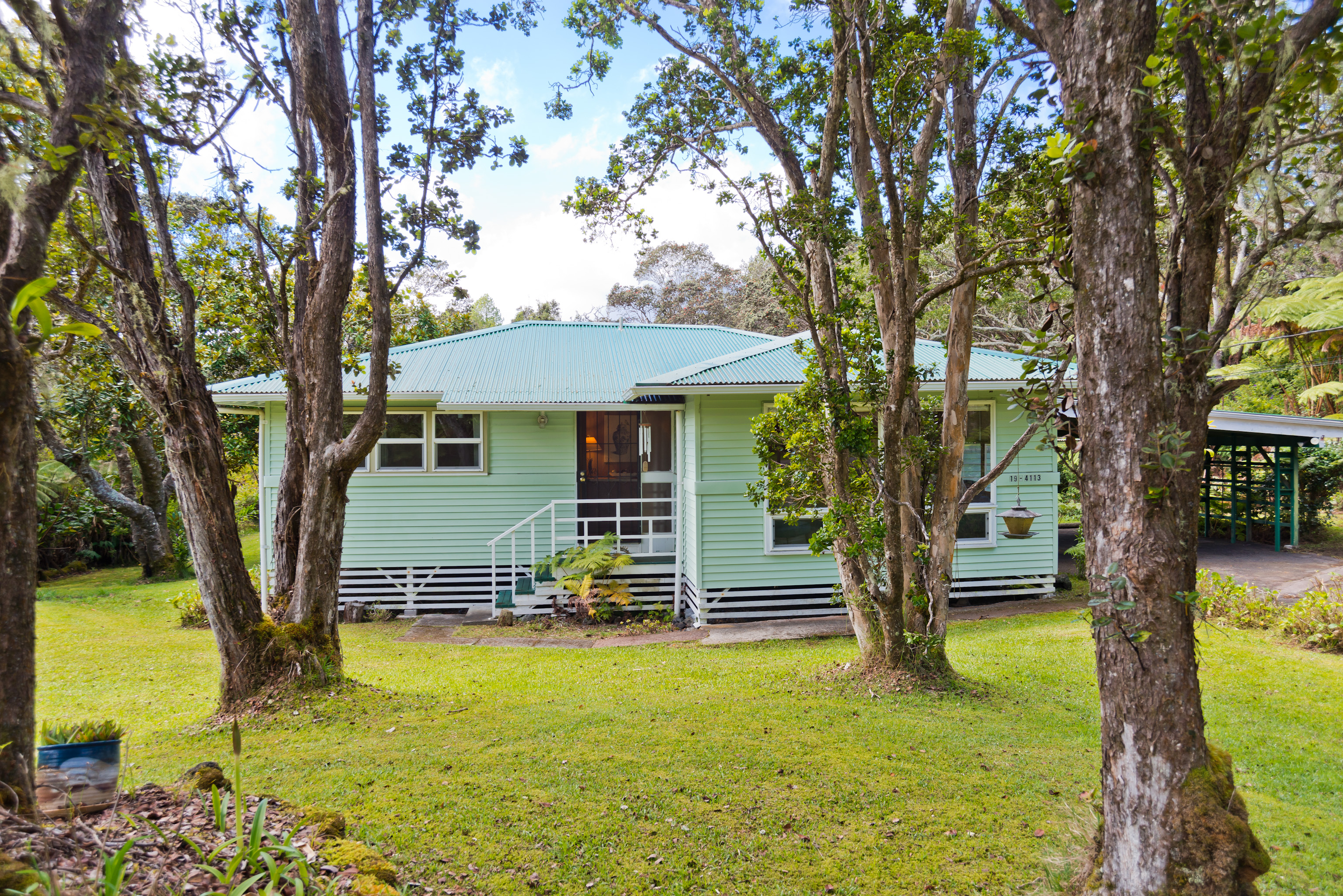 19-4113 Haunani Road Volcano, HI 96785 - Photo 4 of 30 a front view of a house with a garden