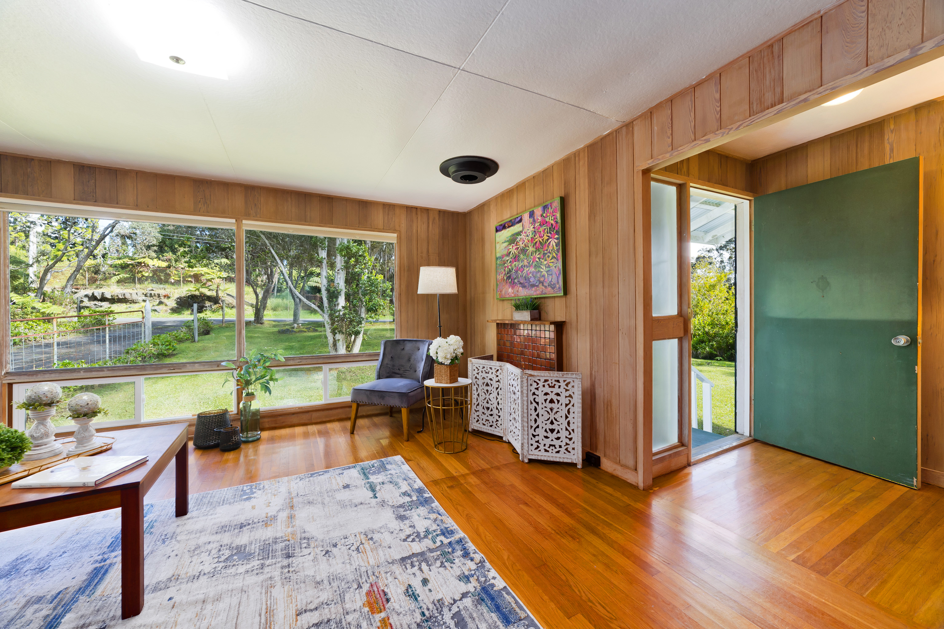 19-4113 Haunani Road Volcano, HI 96785 - Photo 9 of 30 a living room with furniture floor to ceiling window and wooden floor