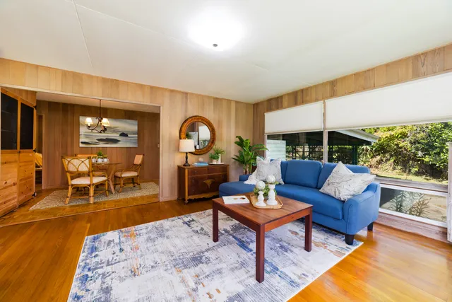 a living room with furniture and a floor to ceiling window
