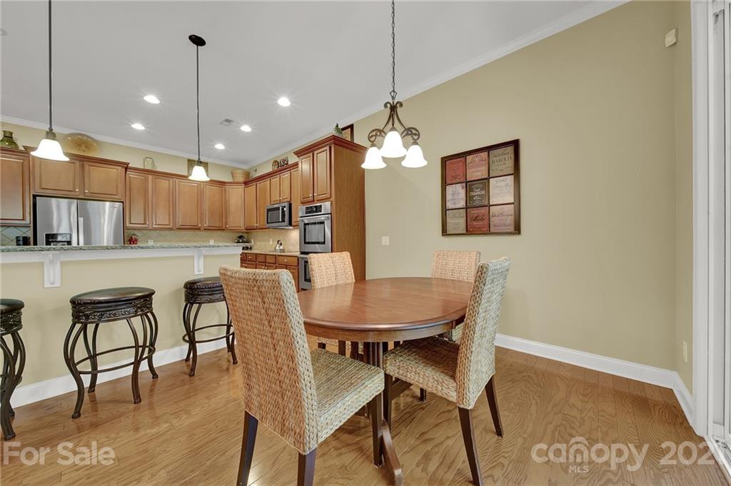 392 Windell Drive Fort Mill, SC 29708 - Photo 13 of 40 a dining room with stainless steel appliances kitchen island granite countertop a dining table chairs and a refrigerator