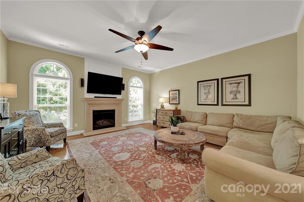 392 Windell Drive Fort Mill, SC 29708 - Photo 15 of 40 a living room with furniture a fireplace and a flat screen tv