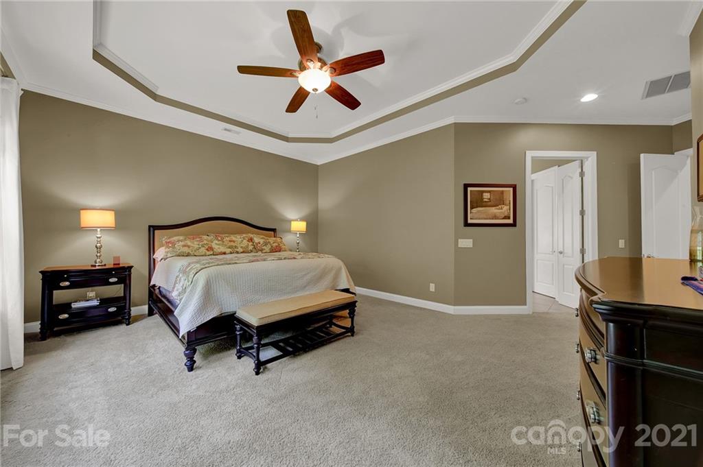 392 Windell Drive Fort Mill, SC 29708 - Photo 19 of 40 a bedroom with a bed and a chandelier