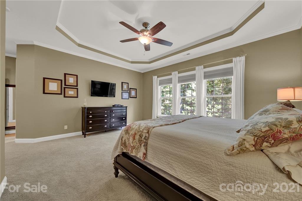 392 Windell Drive Fort Mill, SC 29708 - Photo 20 of 40 a bedroom with a bed next to a window with a flat screen tv