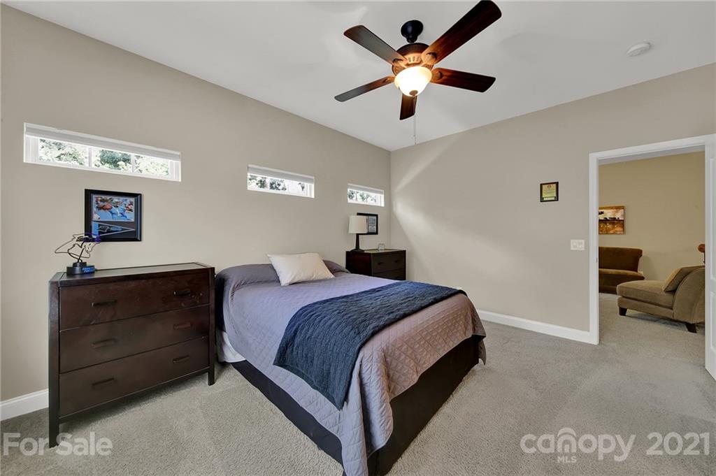 392 Windell Drive Fort Mill, SC 29708 - Photo 24 of 40 a bedroom with a bed and a chandelier