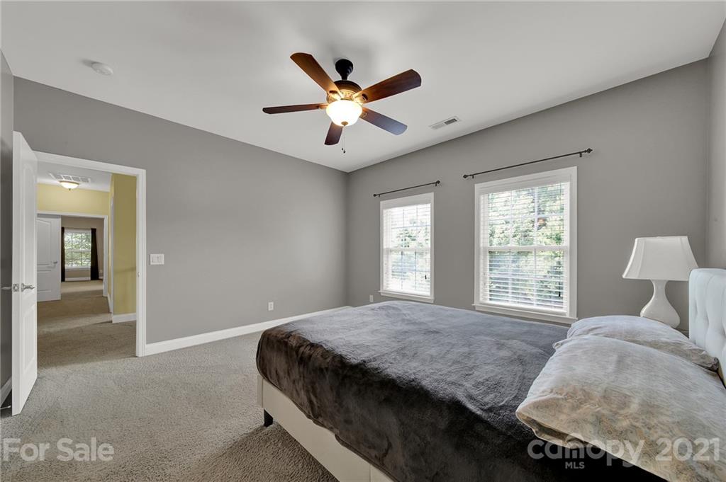 392 Windell Drive Fort Mill, SC 29708 - Photo 26 of 40 a bedroom with a large bed and a ceiling fan