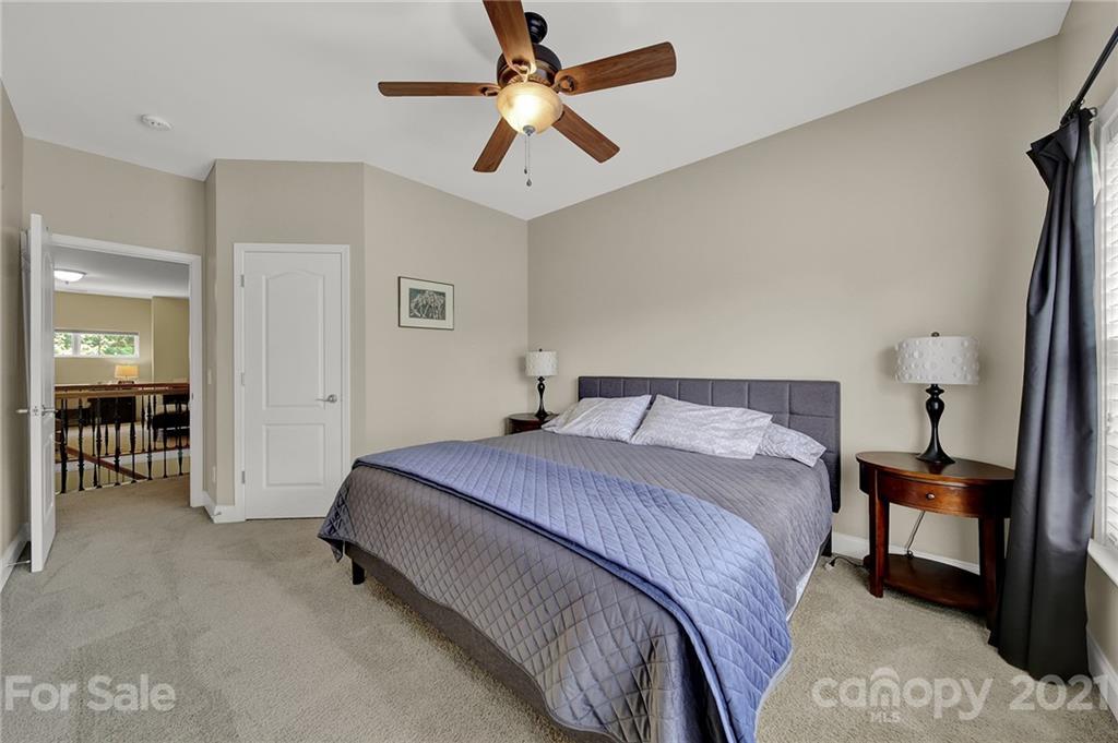 392 Windell Drive Fort Mill, SC 29708 - Photo 28 of 40 a spacious bedroom with a bed and a chandelier