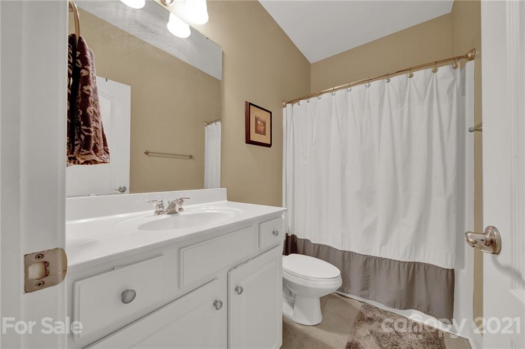 392 Windell Drive Fort Mill, SC 29708 - Photo 30 of 40 a bathroom with a sink a toilet and shower curtain
