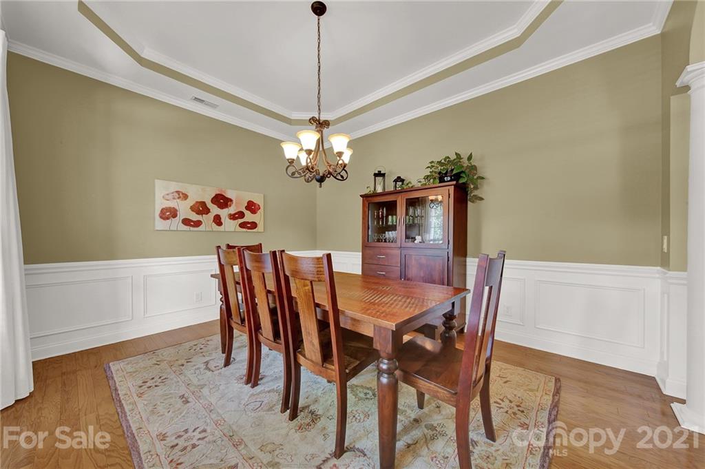 392 Windell Drive Fort Mill, SC 29708 - Photo 6 of 40 a view of a dining room with furniture wooden floor and a chandelier
