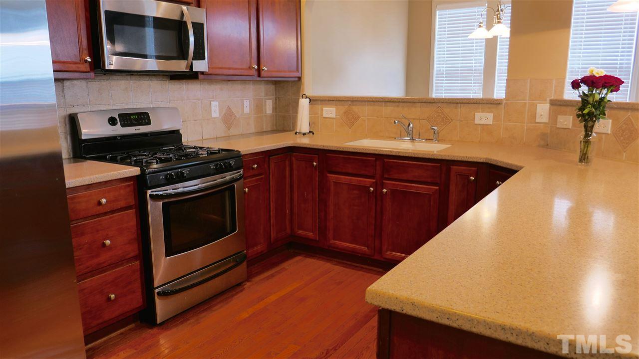 5939 Kohler Lane Raleigh, NC 27616 - Photo 2 of 8 a kitchen with stainless steel appliances granite countertop a stove a microwave and sink