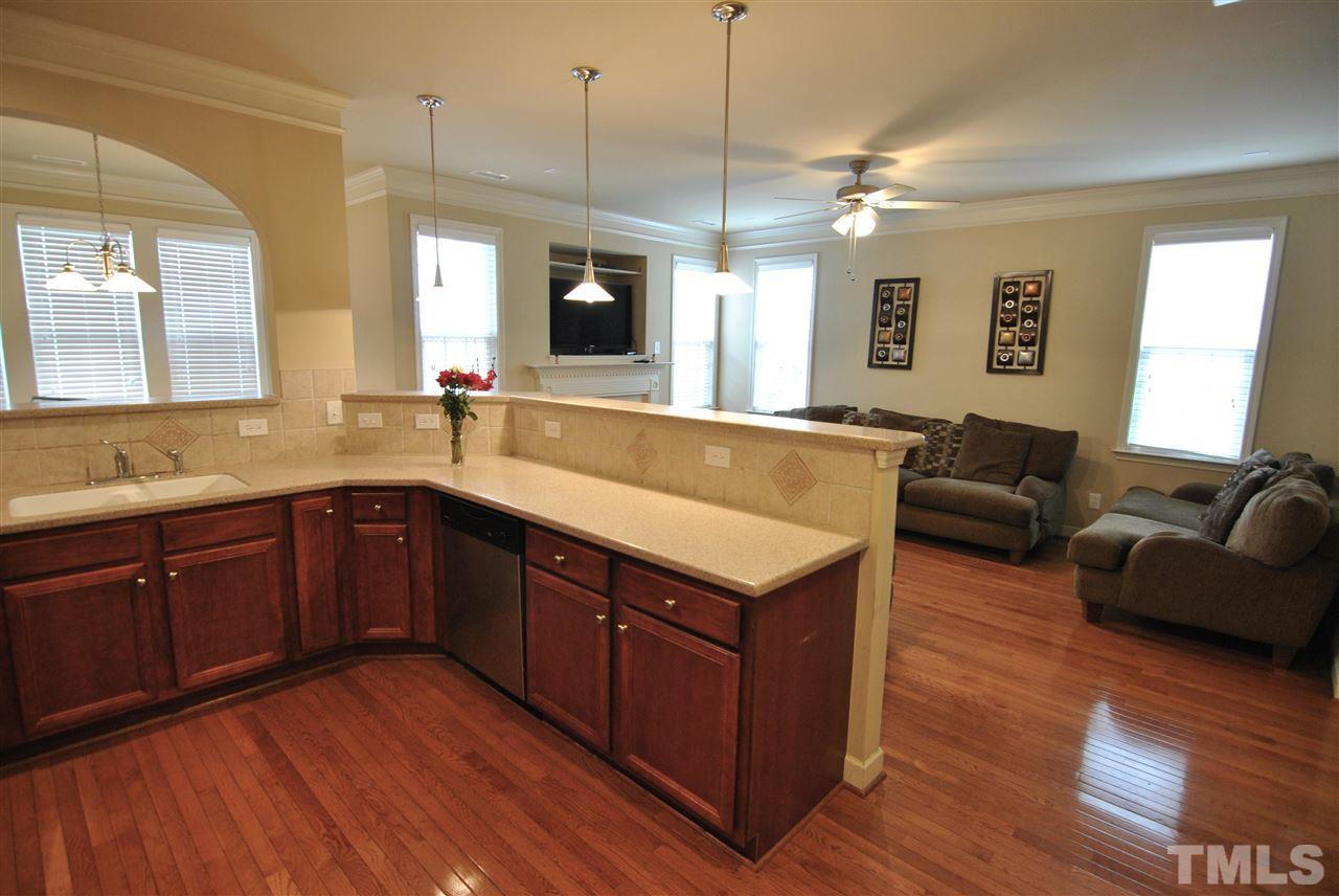 5939 Kohler Lane Raleigh, NC 27616 - Photo 3 of 8 a spacious kitchen with stainless steel appliances granite countertop a sink dishwasher a stove with wooden floor