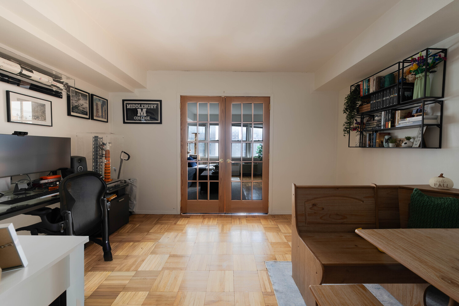155 East 38th Street, Unit 15E Manhattan, NY 10016 - Photo 2 of 5 a living room with furniture a flat screen tv and gym equipment