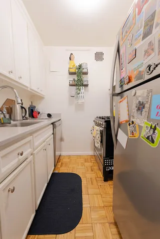 a kitchen with sink cabinets and appliances