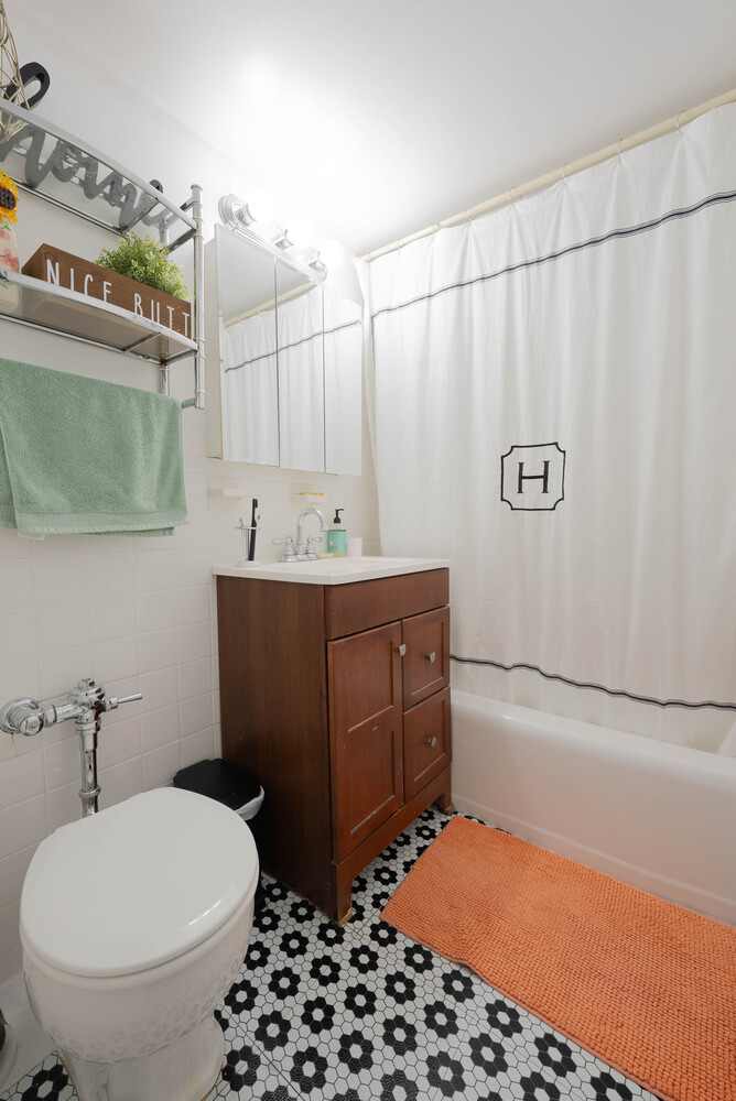 155 East 38th Street, Unit 15E Manhattan, NY 10016 - Photo 5 of 5 a bathroom with a sink a toilet and shower