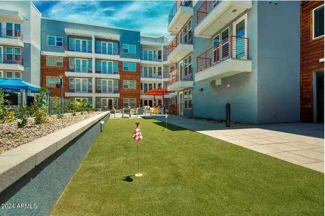 a view of residential houses with yard and swimming pool