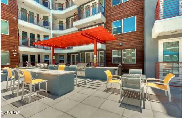 a view of a patio with a table and chairs