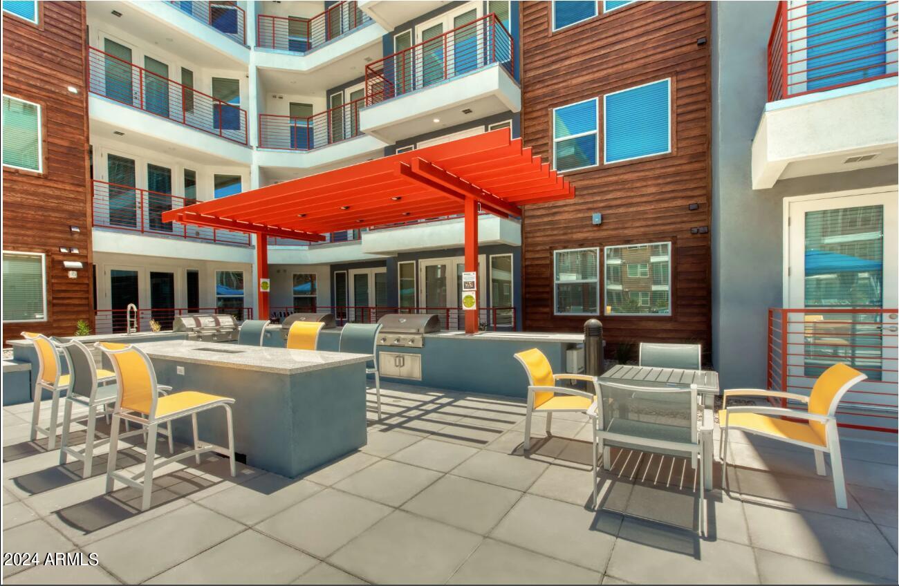 3601 North Central Avenue, Unit A4 Phoenix, AZ 85012 - Photo 8 of 9 a view of a patio with a table and chairs
