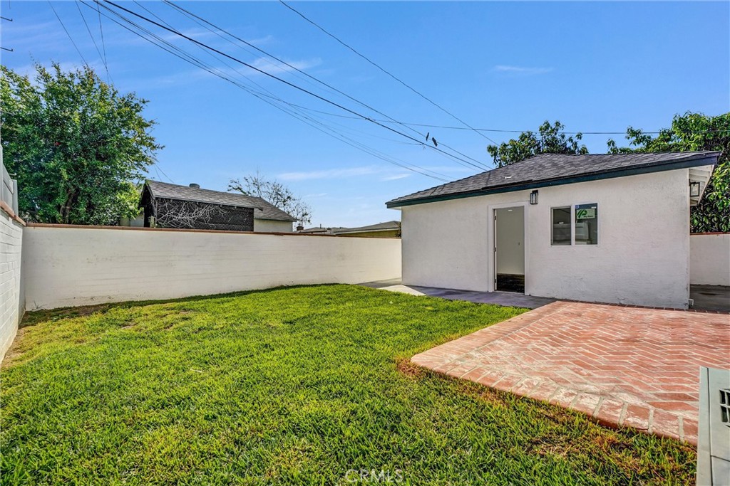 1200 South Castlegate Avenue Compton, CA 90221 - Photo 35 of 39 Backyard left view with garage