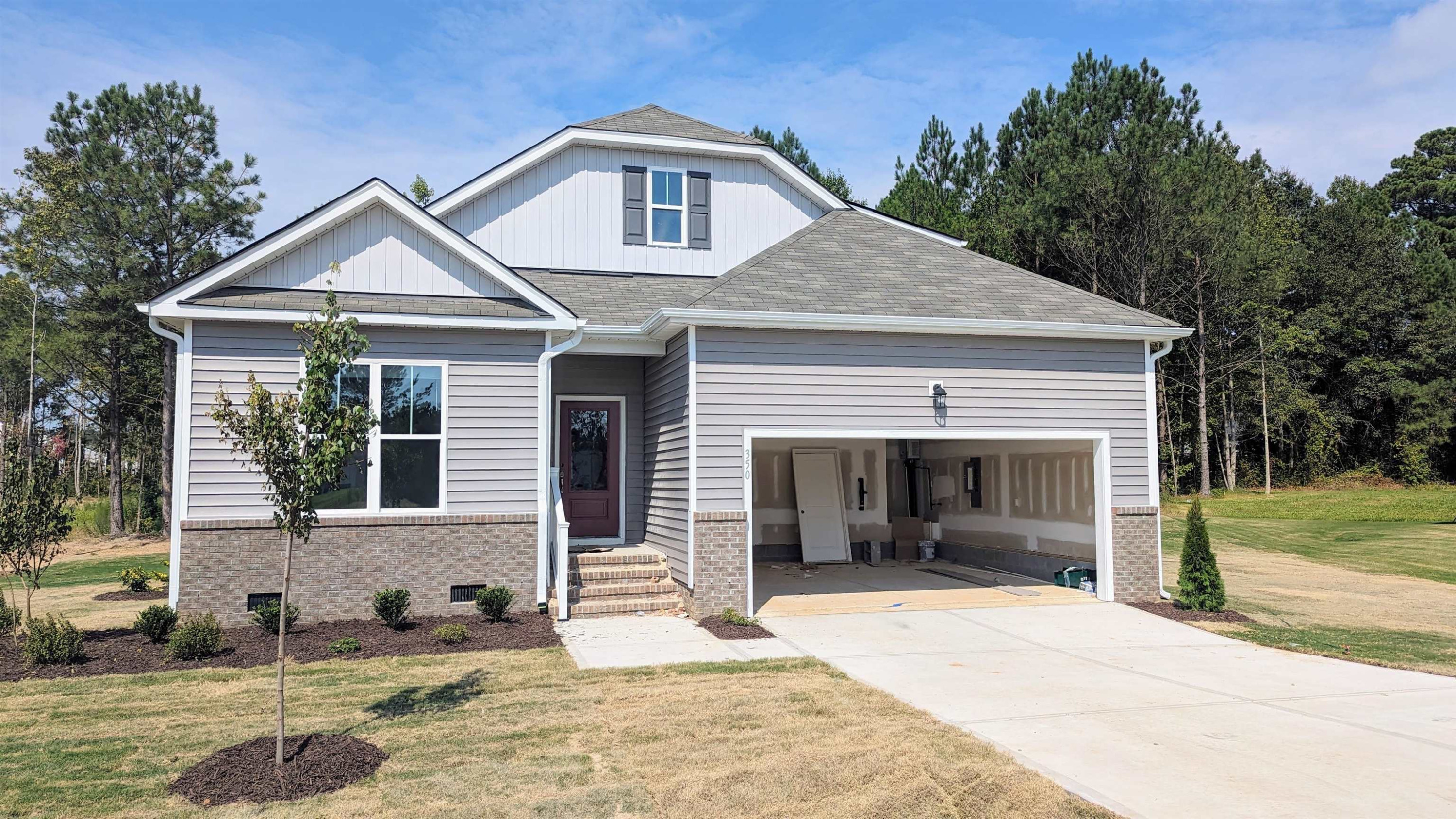 350 Madden Rose Loop Garner, NC 27529 - Photo 1 of 27 a front view of a house with garden