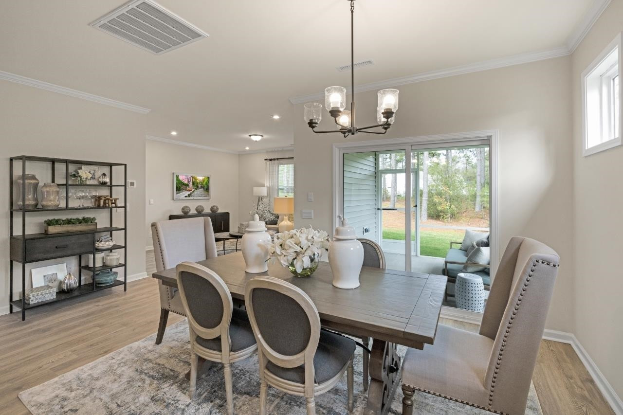 350 Madden Rose Loop Garner, NC 27529 - Photo 12 of 27 a view of a dining room with furniture window and wooden floor