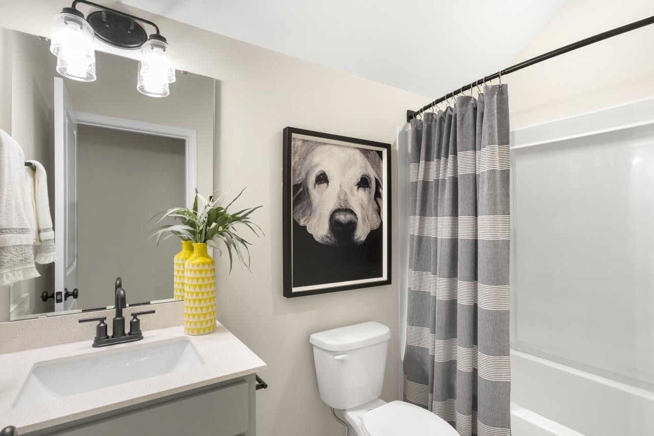 350 Madden Rose Loop Garner, NC 27529 - Photo 18 of 27 a bathroom with a toilet sink and mirror