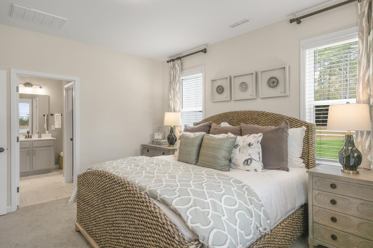 350 Madden Rose Loop Garner, NC 27529 - Photo 19 of 27 a bedroom with a large bed and a window