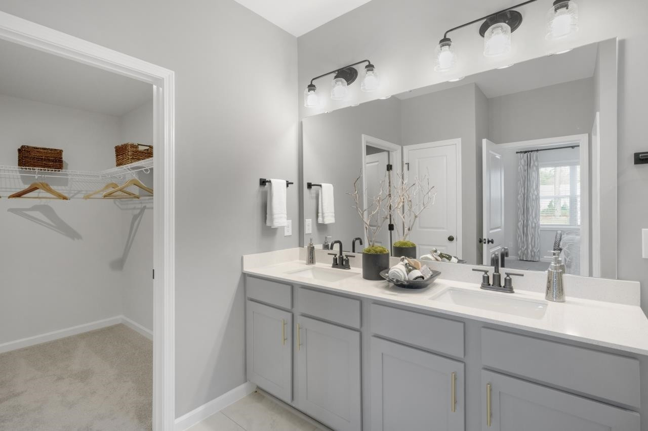350 Madden Rose Loop Garner, NC 27529 - Photo 20 of 27 a bathroom with double sink and a mirror