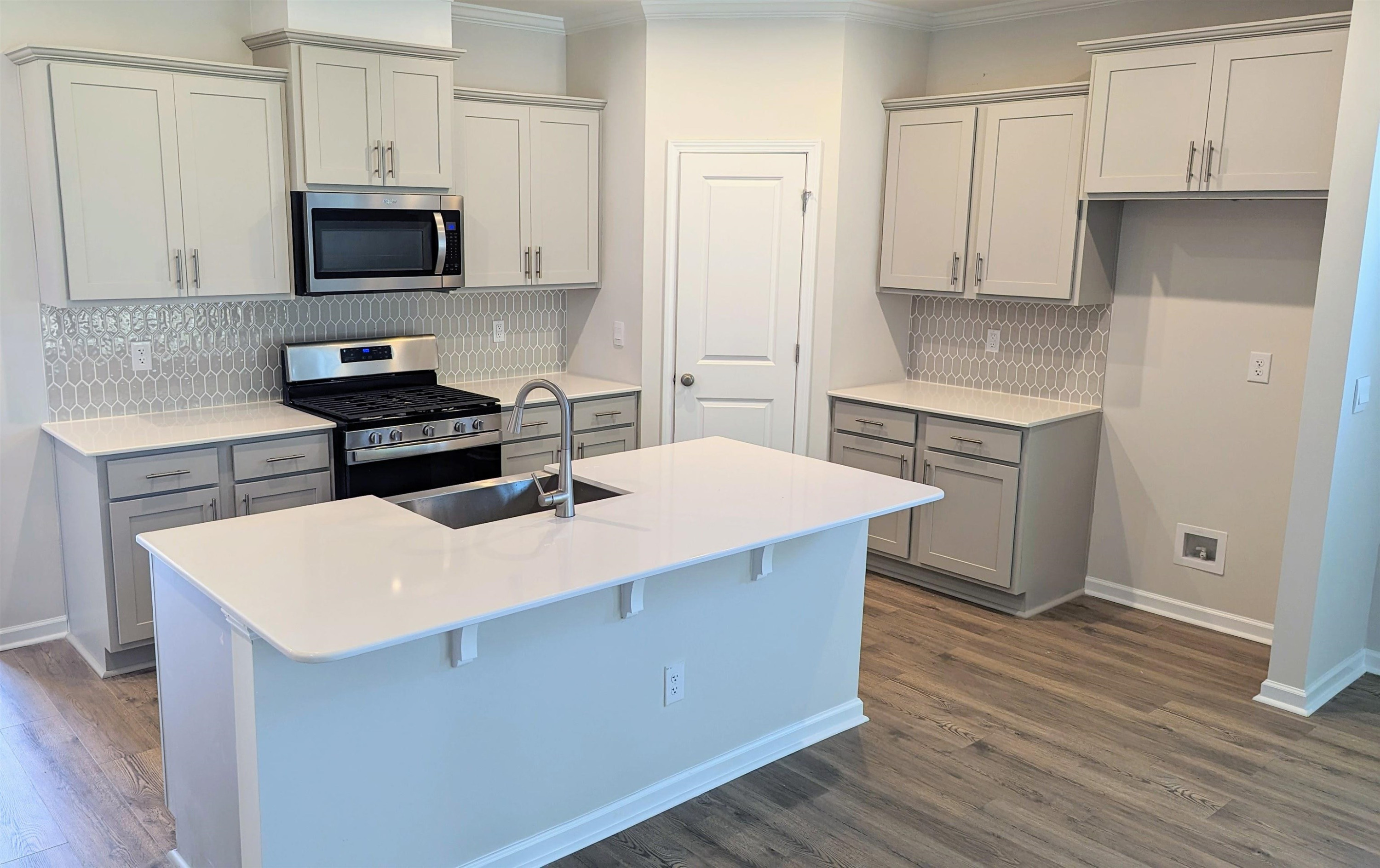 350 Madden Rose Loop Garner, NC 27529 - Photo 2 of 27 a kitchen with stainless steel appliances a stove top oven a sink a refrigerator white cabinets and wooden floor